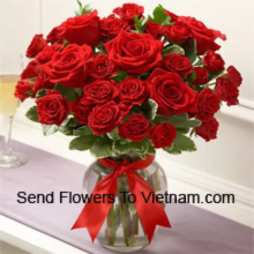 36 Red Roses With Some Ferns In A Glass Vase