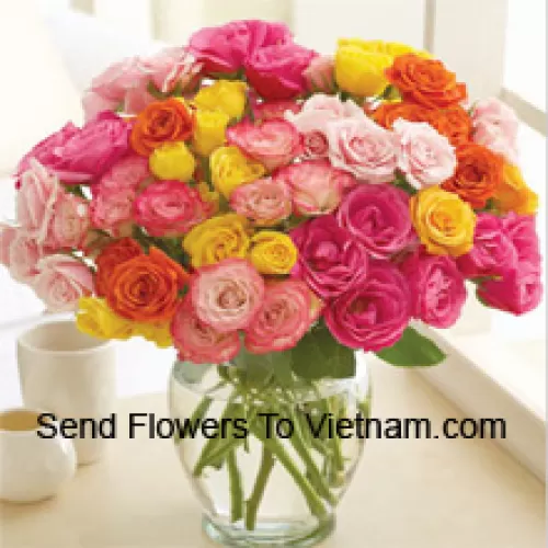 50 Mixed Colored Roses Arranged Beautifully In A Glass Vase